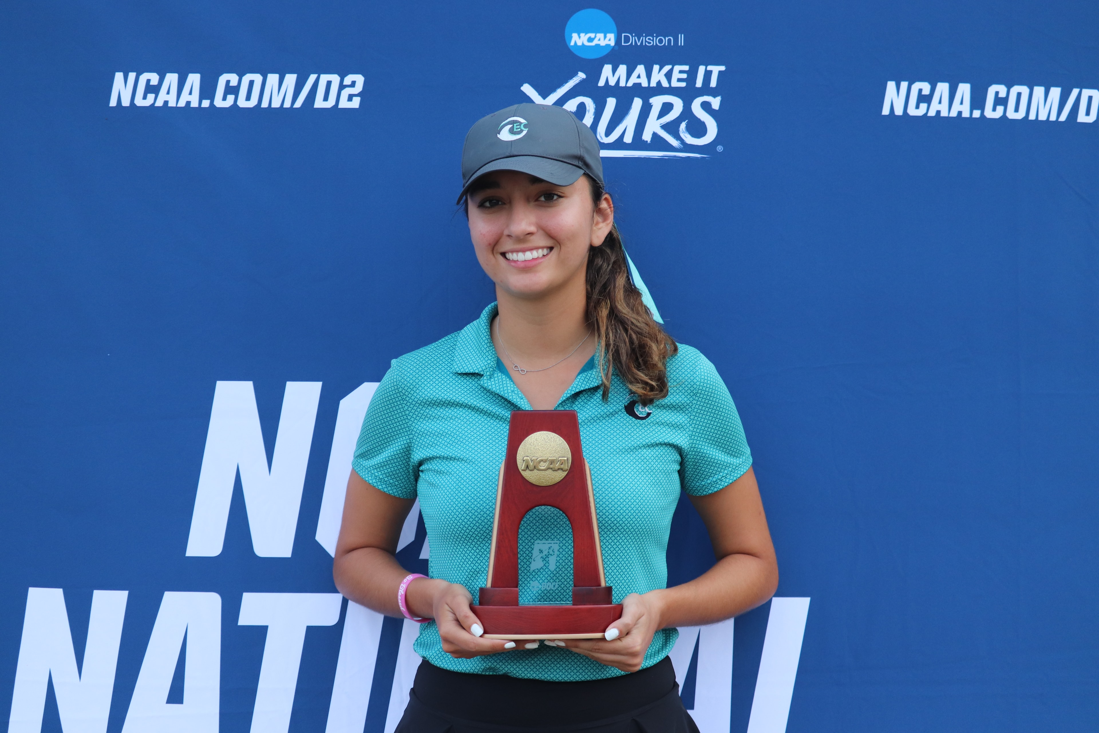 Amelie holding the NCAA Division II trophy